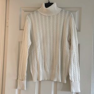 Cream colored cable-knit turtleneck sweater. Great for work or casual.